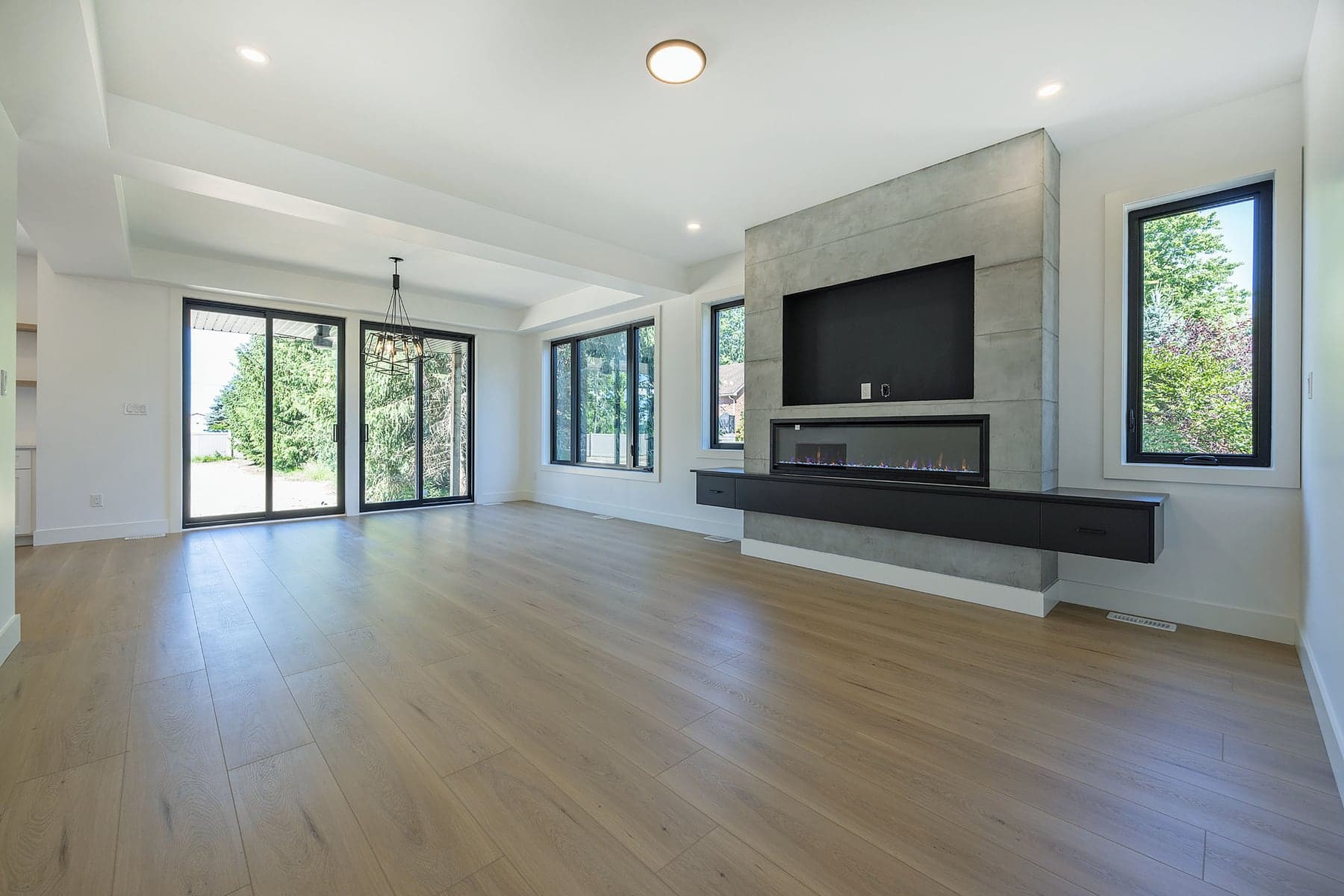 Poured concrete fireplace surround and linear gas fire in a completed SBR great room