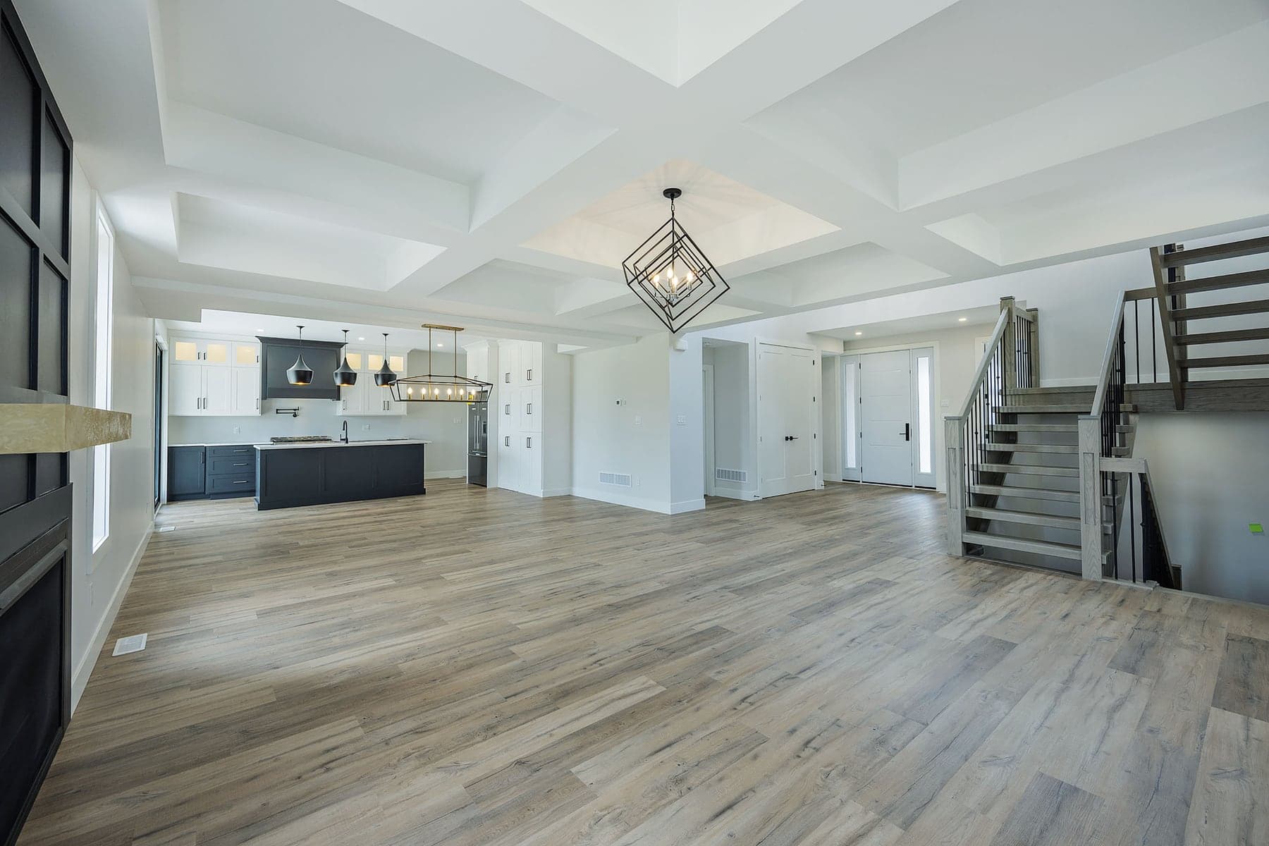 Open-plan great room with a coffered ceiling in a completed SBR home