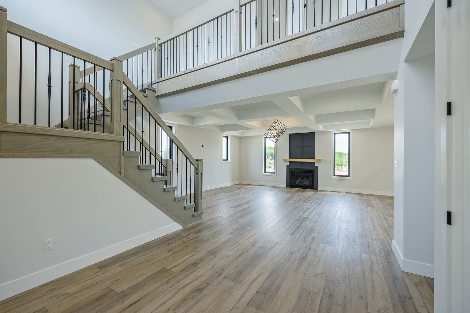 Open staircase and two-storey great room in a completed SBR home
